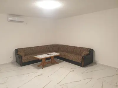 a couch sitting in a room with a coffee table at Apartmani Gusani in Radanovići
