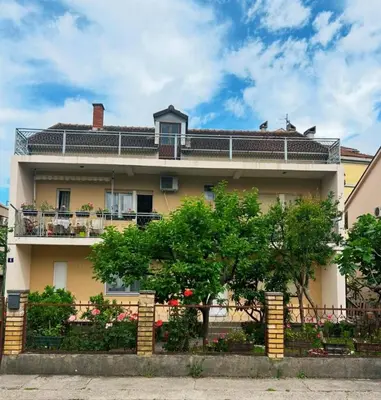 a large house with a fence in front of it at Prestige 4 in Podgorica