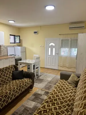a living room with two couches and a table at Prestige 4 in Podgorica