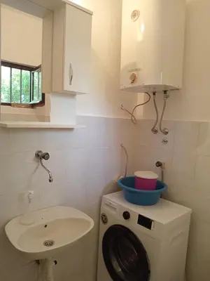 a bathroom with a washing machine and a sink at Prestige 4 in Podgorica