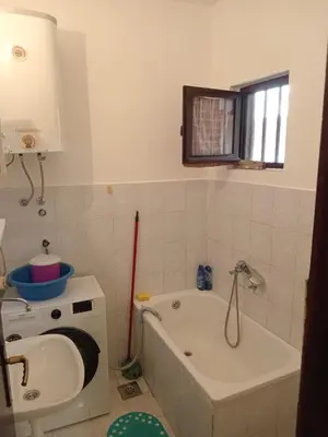 a bathroom with a bath tub and a sink at Prestige 4 in Podgorica
