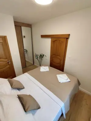 a bedroom with two beds with towels on them at Vidikovac in Kotor