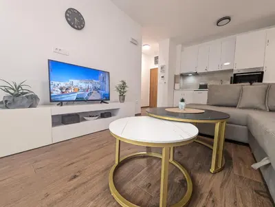 a living room with a couch and a table at Dea apartment in Dobra Voda