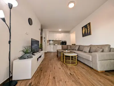 a living room with a couch and a table at Dea apartment in Dobra Voda