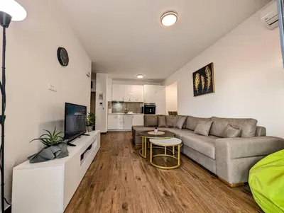 a living room with a couch and a table at Dea apartment in Dobra Voda