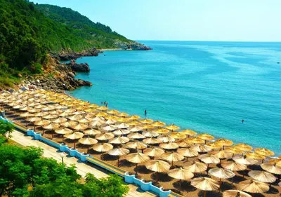 a bunch of umbrellas on a beach next to the water at Villa MARINA CANJ 2 in Čanj