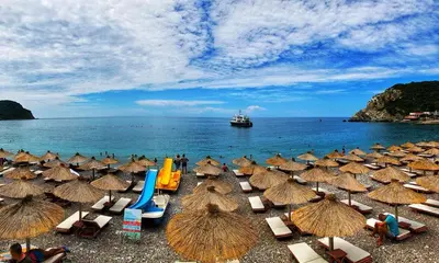 a group of umbrellas and chairs on a beach at Villa MARINA CANJ 2 in Čanj