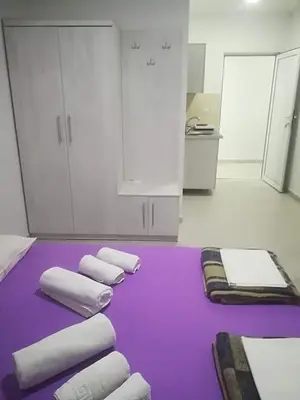 a group of towels on a purple mat in a room at Villa MARINA CANJ 2 in Čanj