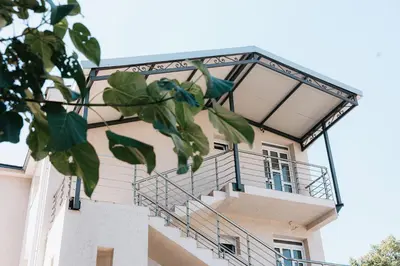a building with a staircase on the side of it at Apartments Podgorička Vila in Podgorica