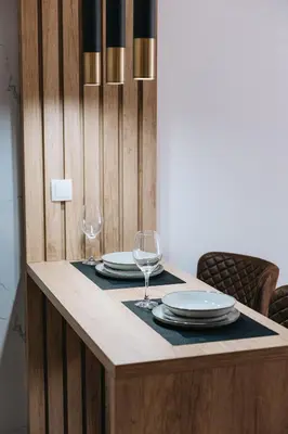 a table with plates and wine glasses on it at Apartments Podgorička Vila in Podgorica