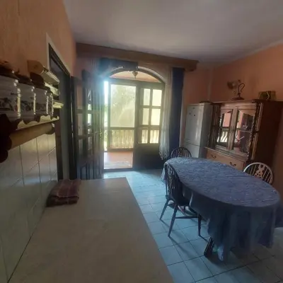 a kitchen with a blue table and a refrigerator at Apartmani Kolovic Susanj in Bar