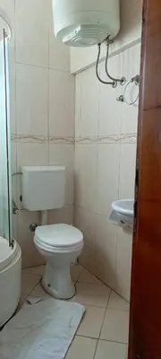 a small bathroom with a toilet and a sink at Apartmani Kolovic Susanj in Bar