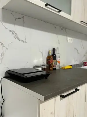 a laptop sitting on top of a counter in a kitchen at Apartment Airport DD in Mitrovići