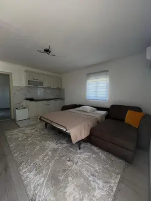 a living room with a bed and a couch at Apartment Airport DD in Mitrovići