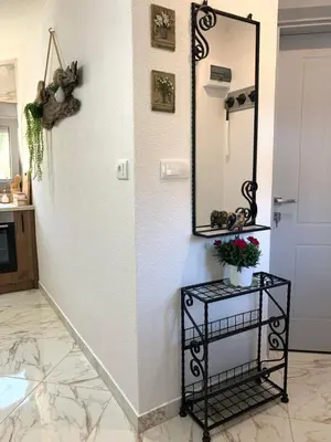a mirror on a wall in a room with a table at Markovic Village Apartments in Ulcinj