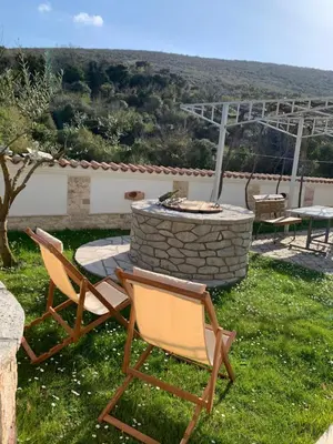 two chairs and a fire pit in a yard at Markovic Village Apartments in Ulcinj