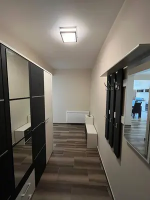 a dressing room with black cabinets and a hallway at Fazenda 2 Becici in Becici