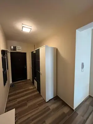 an empty room with a large refrigerator and a door at Fazenda 2 Becici in Becici