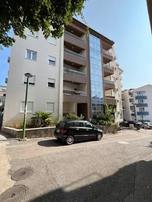 a black car parked in front of a building at Fazenda 2 Becici in Becici