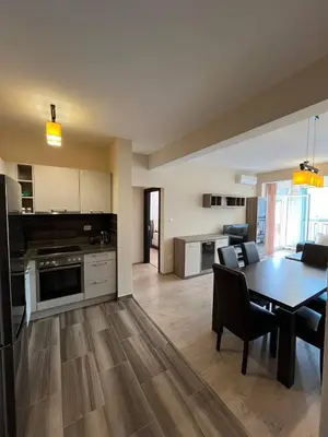 a kitchen and living room with a table and a dining room at Fazenda 2 Becici in Becici