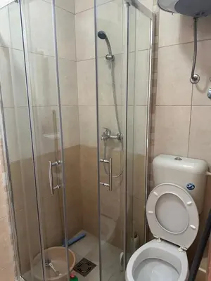 a bathroom with a toilet and a glass shower at Apartman MONTE Sea BEČIĆI in Becici