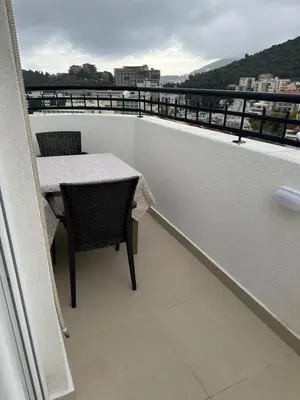 a balcony with a table and chairs and a view at Apartman MONTE Sea BEČIĆI in Becici
