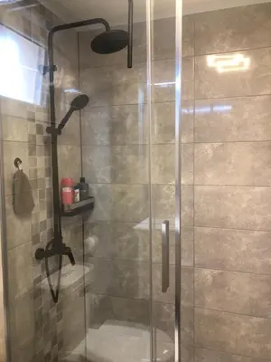 a shower with a glass door in a bathroom at BonMare.apt4 in Dobra Voda