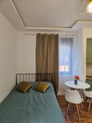 a bedroom with a bed and a table and a window at Montedream apartments in Bar