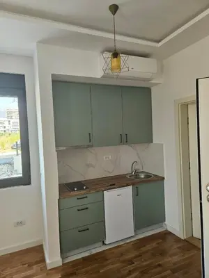 a kitchen with green cabinets and a sink at Montedream apartments in Bar
