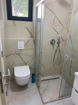 a bathroom with a shower and a toilet at Montedream apartments in Bar