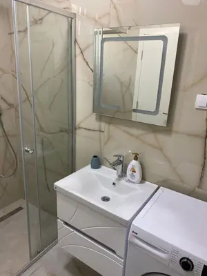 a white bathroom with a sink and a shower at Montedream apartments in Bar