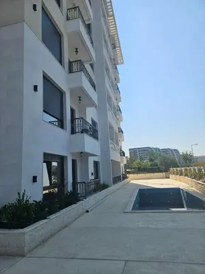 a large apartment building with a pool in front of it at Montedream apartments in Bar