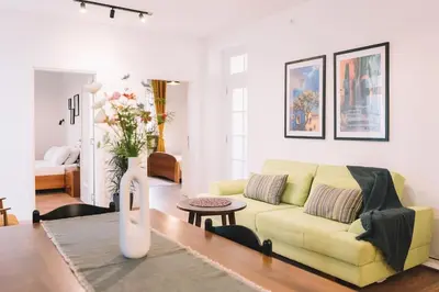 a living room with a yellow couch and a table at Casa Hollaj in Vladimir