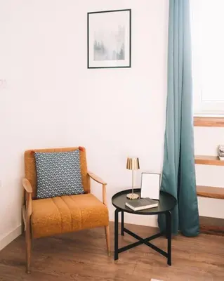 a room with a chair and a table with a laptop at Casa Hollaj in Vladimir