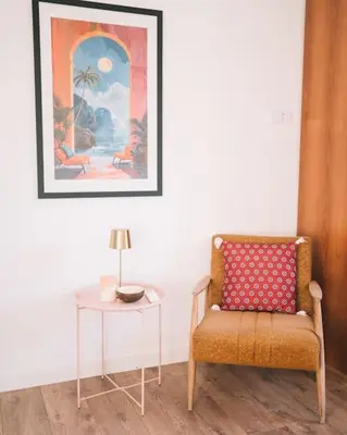 a living room with a chair and a table at Casa Hollaj in Vladimir