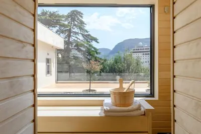 a window in a tiny house looking out at the mountains at Modular Sea view Spa Studio in Kotor