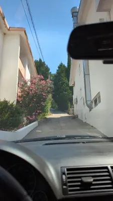 a view from the inside of a car looking down a street at Panorama in Čanj
