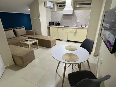 a living room with a couch and a table at Lucky center Apartment in Podgorica