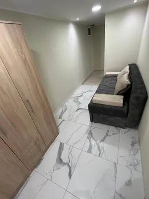 a living room with a couch and a marble floor at Lucky center Apartment in Podgorica