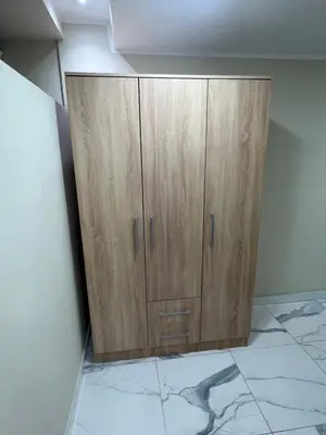 a wooden cabinet in the corner of a room at Lucky center Apartment in Podgorica