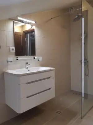 a bathroom with a white sink and a shower at Apartments Becici in Budva
