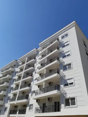 an apartment building with balconies against a blue sky at Apartments Becici in Budva