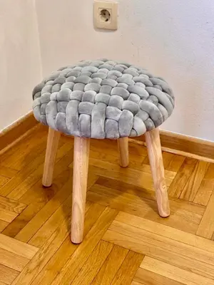 a stool sitting on a wooden floor in a room at Apartment Milana in Konik