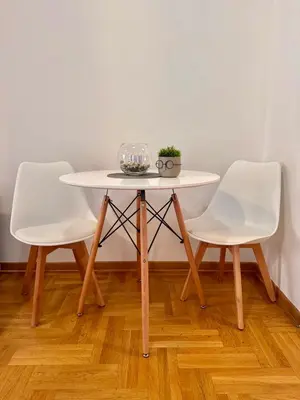 a white table with two white chairs and a plant on it at Apartment Milana in Konik