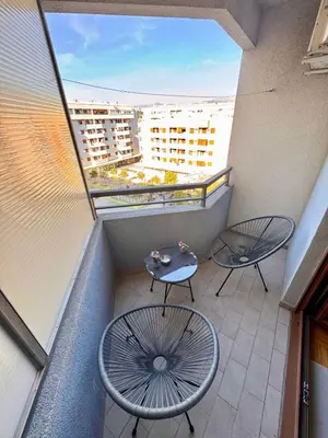 a balcony with two chairs and a table on it at Apartment Milana in Konik
