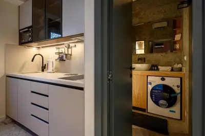 a kitchen with a washer and dryer in a room at Modular Central Studio in Kotor