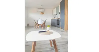a kitchen and dining room with a white table and chairs at Suite Madric in Pečurice