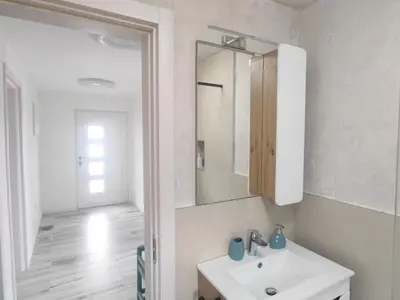 a bathroom with a sink and a mirror at Suite Madric in Pečurice
