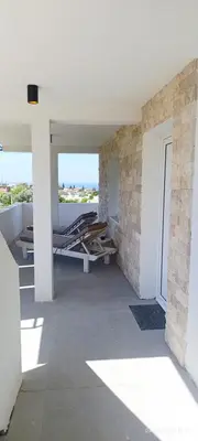 a room with a table and chairs on a building at Suite Madric in Pečurice