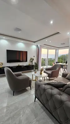 a living room with couches and a flat screen tv at Sisters residence in Kotor